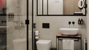 a bathroom with a sink and a toilet and a shower at Radisson RED Berlin Kudamm in Berlin