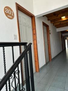 an empty hallway with a door in a building at Hotel towi in Creel