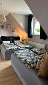 a bedroom with two beds and a staircase at Domki Lubiane in Brenna +82 photos