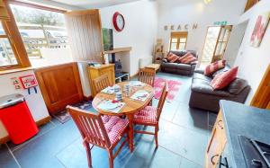 a living room with a table and chairs and a couch at CROYDE THATCHERS HIDEAWAY 2 Bedrooms in Croyde