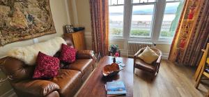 a living room with a couch and a coffee table at Ards House in Oban