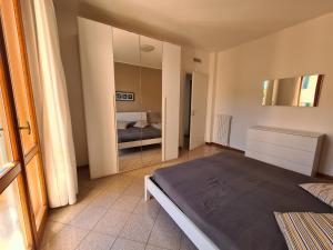 a bedroom with a bed and a large mirror at Villaggio Mietta in Castiglioncello