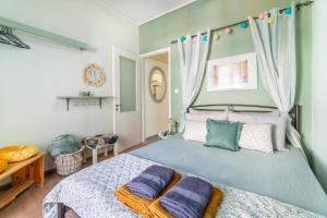 a bedroom with a bed with purple pillows on it at Corfu Central Casa Seniora Stamy in Ágios Rókkos