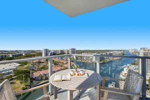 a balcony with a table and chairs and a view of the water at High Floor with Stunning Views, Amazing Pools in Hollywood