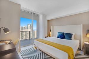 a bedroom with a large bed and a large window at High Floor with Stunning Views, Amazing Pools in Hollywood