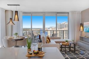 a living room with a white couch and large windows at High Floor with Stunning Views, Amazing Pools in Hollywood +56 photos
