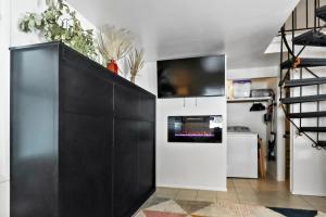 a living room with a fireplace and a tv at Boho Modern Retreat with Mountain Views Unit 1 Durango in Durango