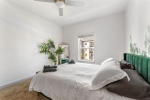 Habitación blanca con cama y ventana en Lush Green Retreat 10 Min to Parks Pets Allowed, en Orlando