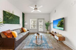 a living room with a couch and a table at Lush Green Retreat 10 Min to Parks Pets Allowed in Orlando