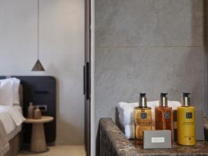 a room with three bottles of essential oils on a counter at Alaso Design Suites in Fira