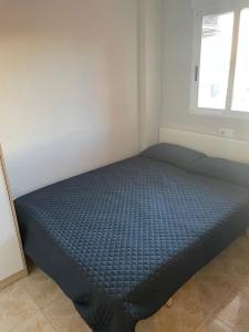 a bed in a room with a blue mattress at Parque De Las Naciones Europa II in Torrevieja