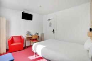 a bedroom with a white bed and a red chair at Altona in Paris