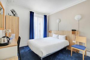 a bedroom with a bed and a desk with a chair at Altona in Paris