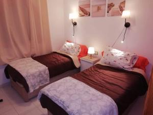 Postel nebo postele na pokoji v ubytování Residencial Sol Suite 2