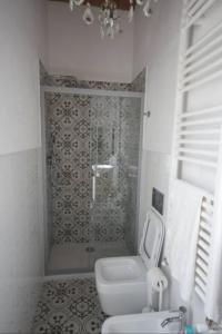 a bathroom with a shower with a toilet and a sink at Casa Francesca in Scarlino