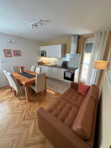 a living room and kitchen with a couch and a table at Apartment with balcony Hi&scaron;a Brdo 48 in Bovec