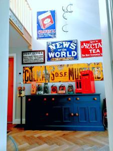 a room with a blue cabinet with signs on the wall at Englefield Guesthouse in Goathland