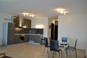 a kitchen and dining room with a table and chairs at Blue Sea Horizon in Iraklitsa