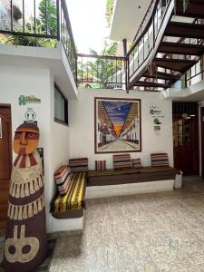 ein Zimmer mit zwei Bänken und einem Gemälde an der Wand in der Unterkunft Hotel Ñuñurco Travellers in Chachapoyas