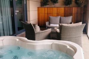 a bath tub with chairs and a couch in a room at Casa Hotel in Chesterfield