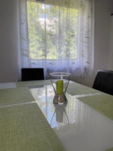a glass vase with a candle on a table at Haus Landruhe in Greifenburg