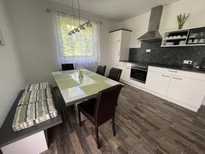 a kitchen with a table and chairs in a room at Haus Landruhe in Greifenburg