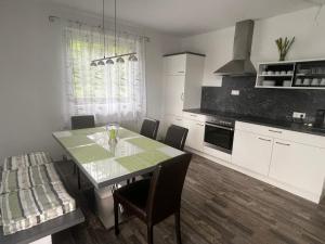 a kitchen with a table and chairs in a room at Haus Landruhe in Greifenburg