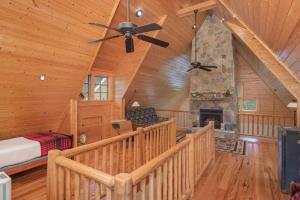a bedroom with a fireplace in a log cabin at Quiet Getaway at Wayward Cottage in Pisgah