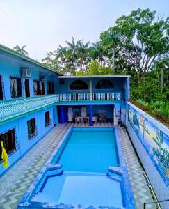 a blue house with a swimming pool at Hotel Alto Amazonas in Leticia