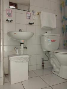 a bathroom with a sink and a toilet at Hostal Benalcazar in Quito