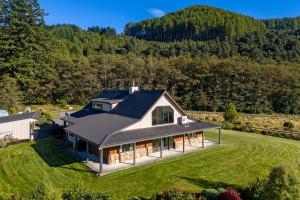 an aerial view of a house on a green field at Mt Hutts Closest Accom in Mount Hutt