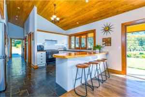 a kitchen with a large counter and stools at Mt Hutts Closest Accom in Mount Hutt