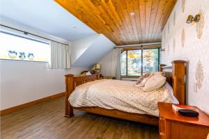 a bedroom with a bed and a large window at Mt Hutts Closest Accom in Mount Hutt