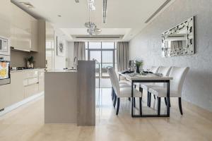 a kitchen and dining room with a table and chairs at Frank Porter - The 8 in Dubai