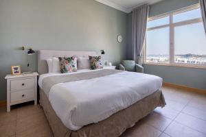um quarto com uma cama grande e uma janela grande em Frank Porter - Al Haseer em Dubai