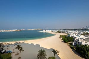 a view of a beach with palm trees and buildings at Frank Porter - Al Haseer in Dubai
