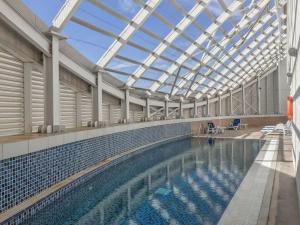 a large swimming pool with a glass ceiling at Frank Porter - The Bridge in Dubai