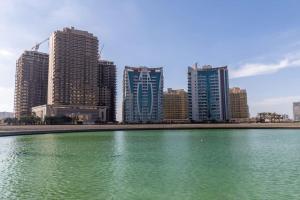 a large body of water in front of a city at Frank Porter - The Bridge in Dubai