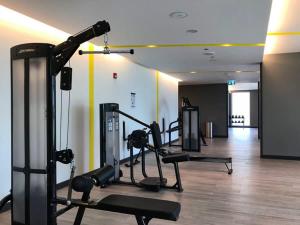 a gym with several tread machines in a room at Frank Porter - Creek Horizon T1 in Dubai