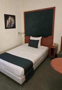 a bedroom with a large bed in a room at Hotel Le Dome in Brussels