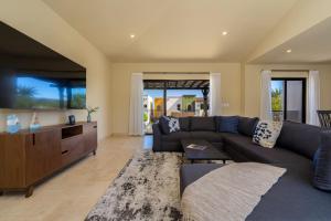 a living room with a couch and a table at Spacious New 3BR Villa at Copala-Quivira in Cabo San Lucas