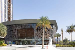 a building with a palm tree in front of it at Frank Porter - BLVD Heights T1 in Dubai