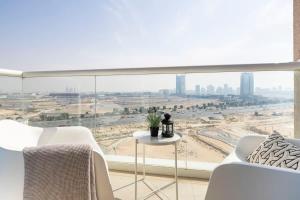 a living room with a large window with a view of a city at Frank Porter - Siraj Tower in Dubai