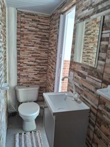 a bathroom with a toilet and a sink at Pousada Marambaia Café in Barra de Guaratiba