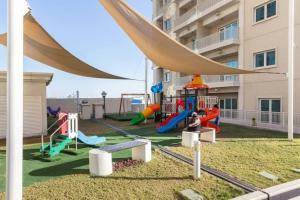 a playground in front of a apartment building at Frank Porter - Suburbia in Dubai