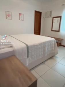 a bed in a room with a white mattress at Passeios jet home in Angra dos Reis