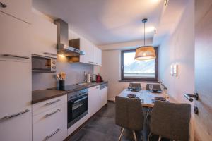 a kitchen with a table and chairs and a window at Apartment Michael in Neustift im Stubaital