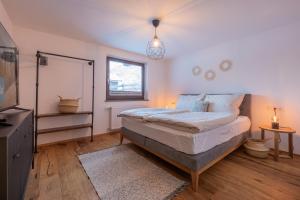 a bedroom with a large bed and a window at Apartment Michael in Neustift im Stubaital