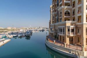 a group of boats in a river next to a building at Frank Porter - Palm Views East in Dubai