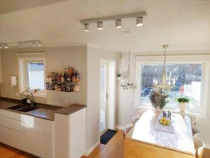 a kitchen with a table and a large window at Nice holiday accommodation in picturesque Bralanda outside Vanersborg in Brålanda